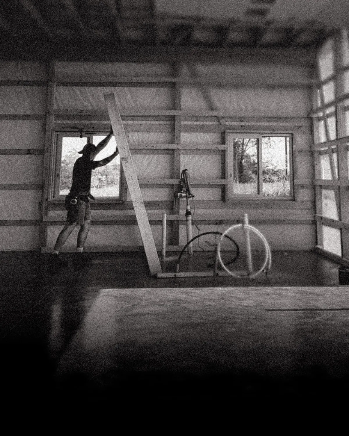 Framing-stage shot of the studio build — exposed timber and rough framing.